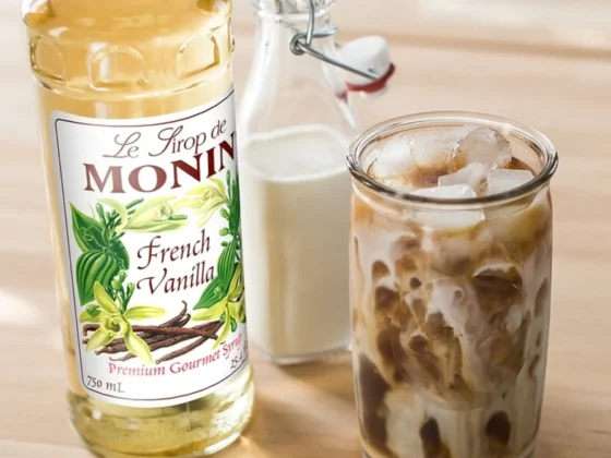 a bottle of monin french vanilla coffee syrup and a glass of milk