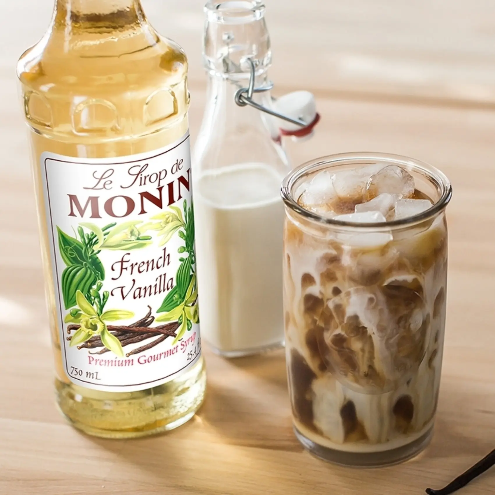a bottle of monin french vanilla coffee syrup and a glass of milk