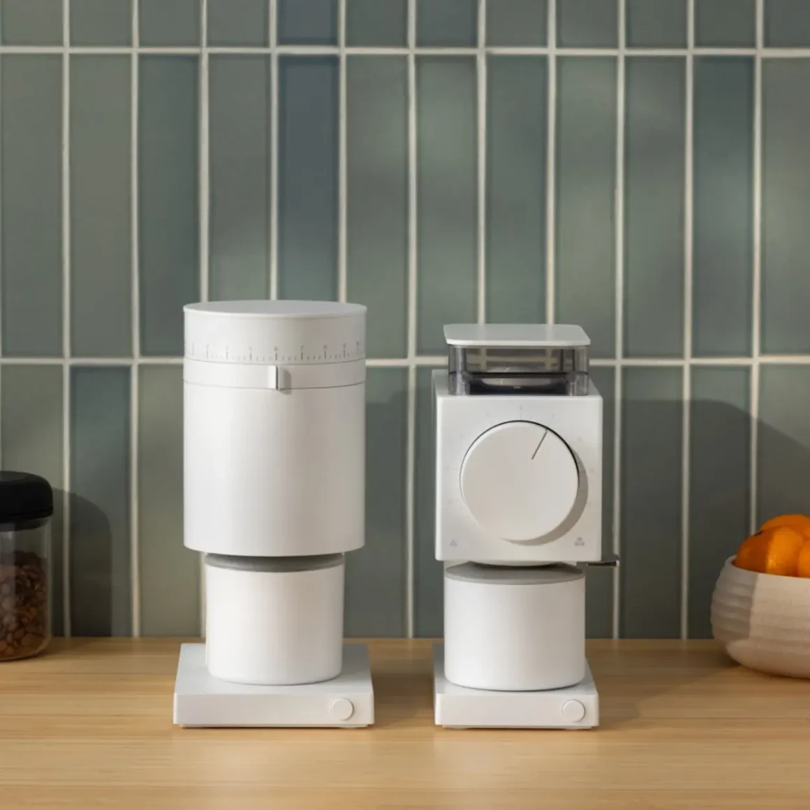 a fellow opus coffee grinder and a ode brew coffee grinder on a table