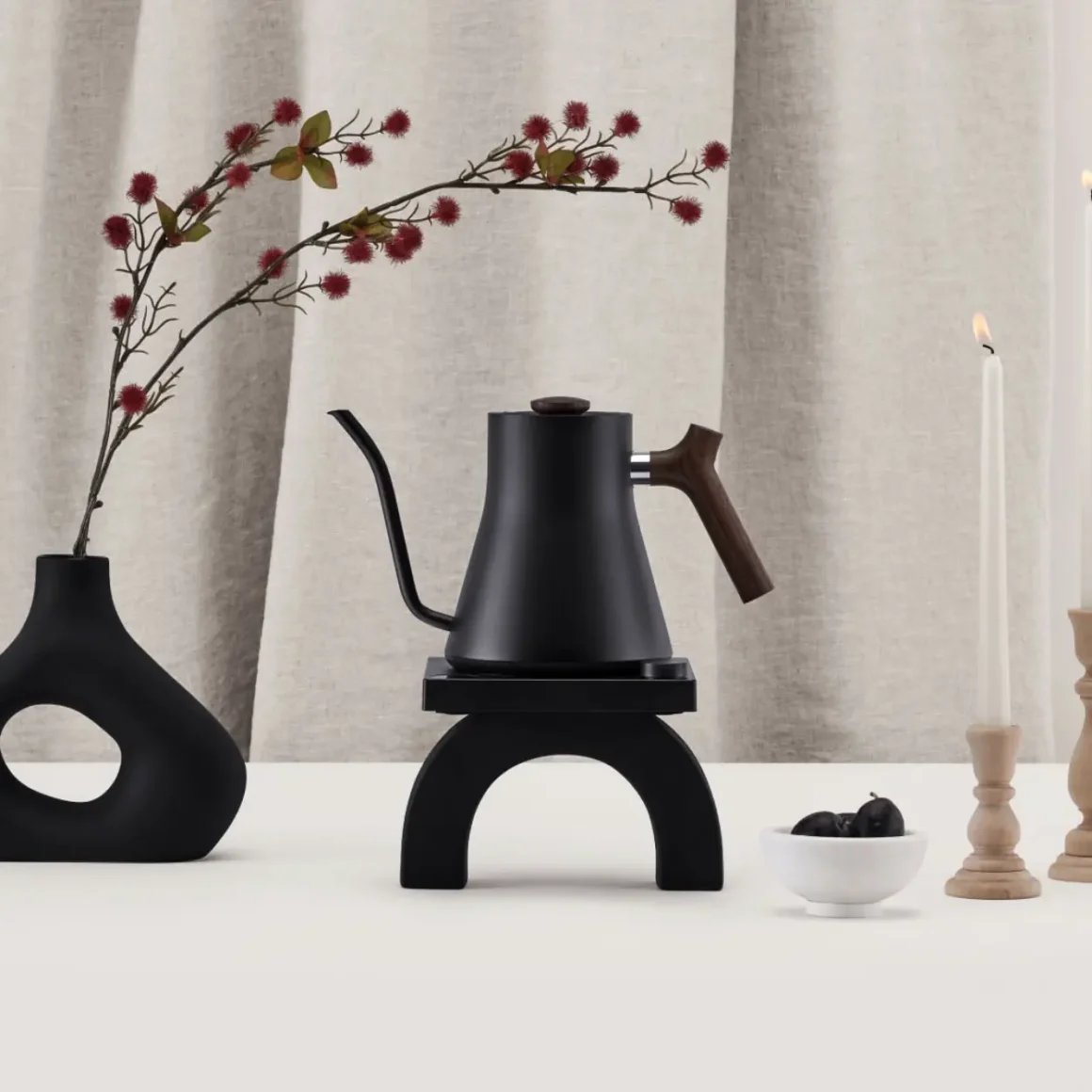 a fellow stagg ekg electric kettle on a table with a a black vase