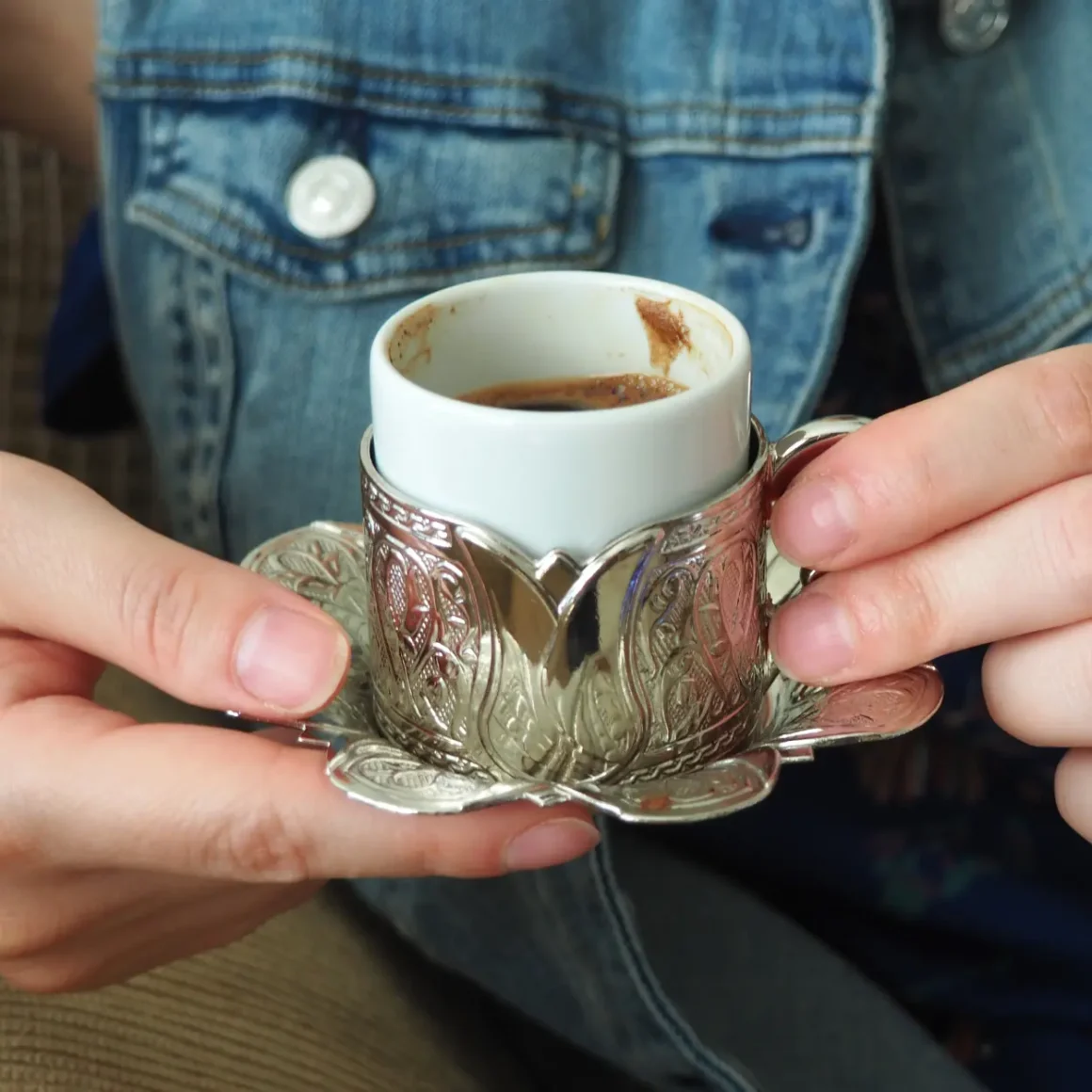 a person holding a cup of coffee