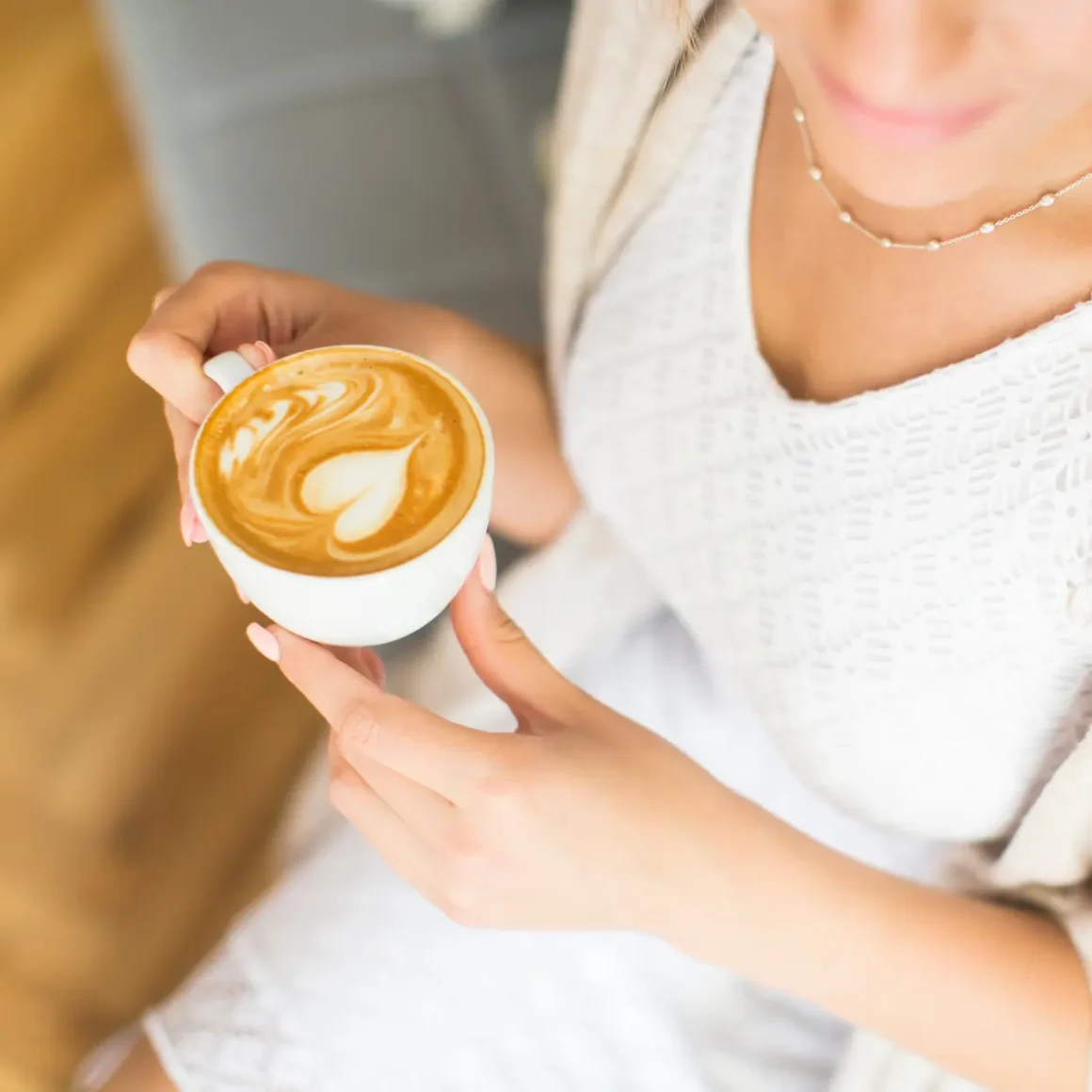 a person holding a cup of coffee
