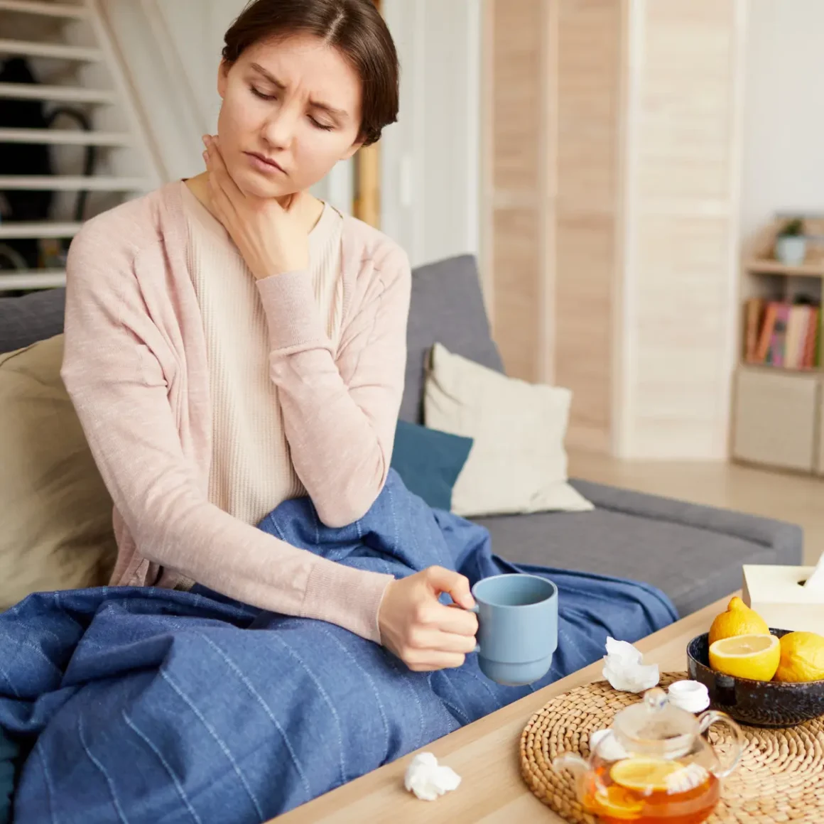 women holding her throat in discomfort