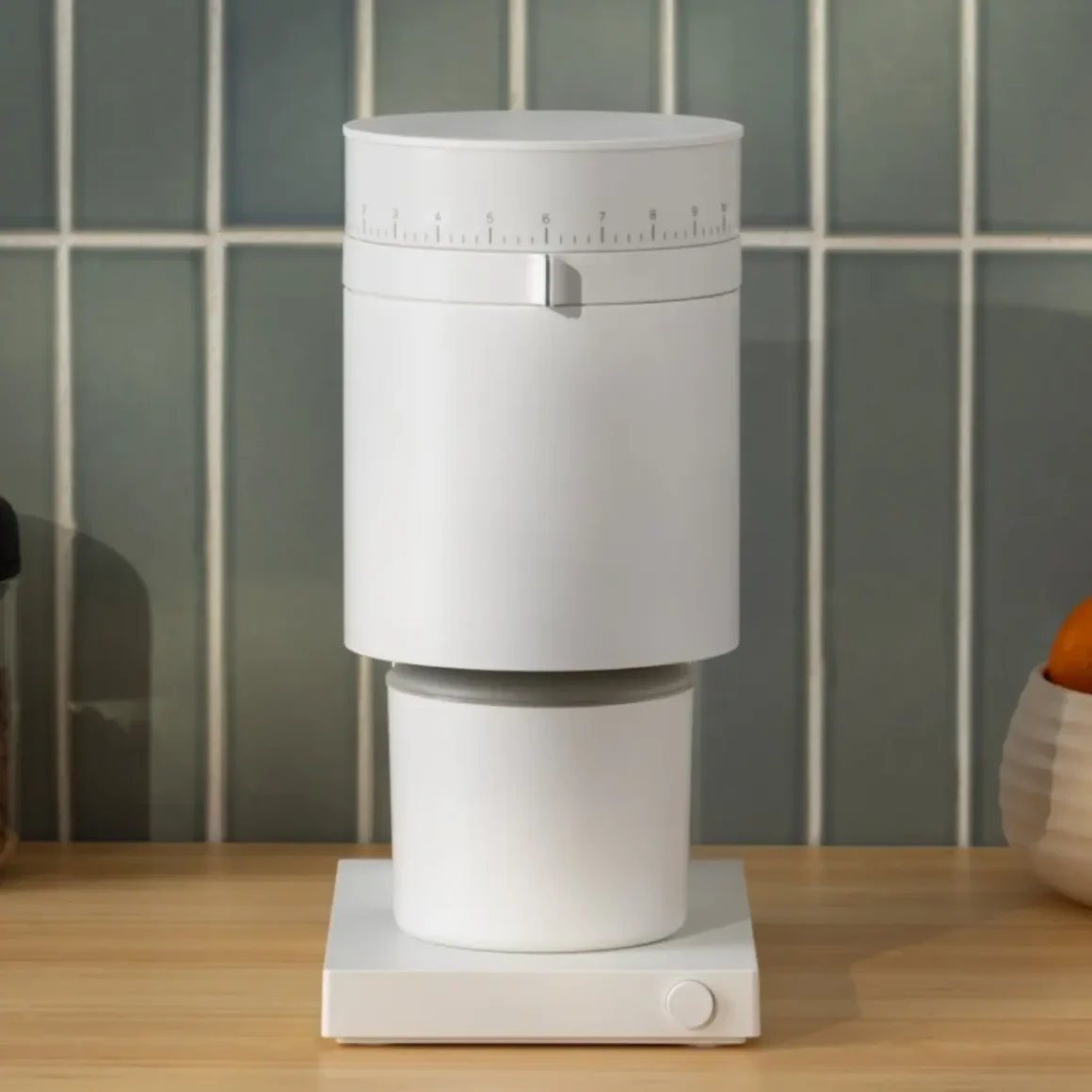 a white coffee grinder on a counter