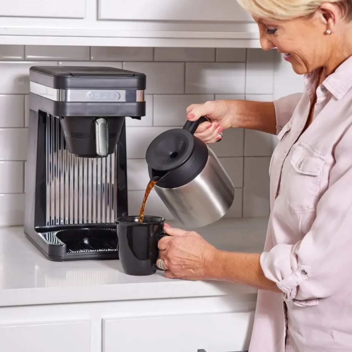 a woman pouring coffee into a cup