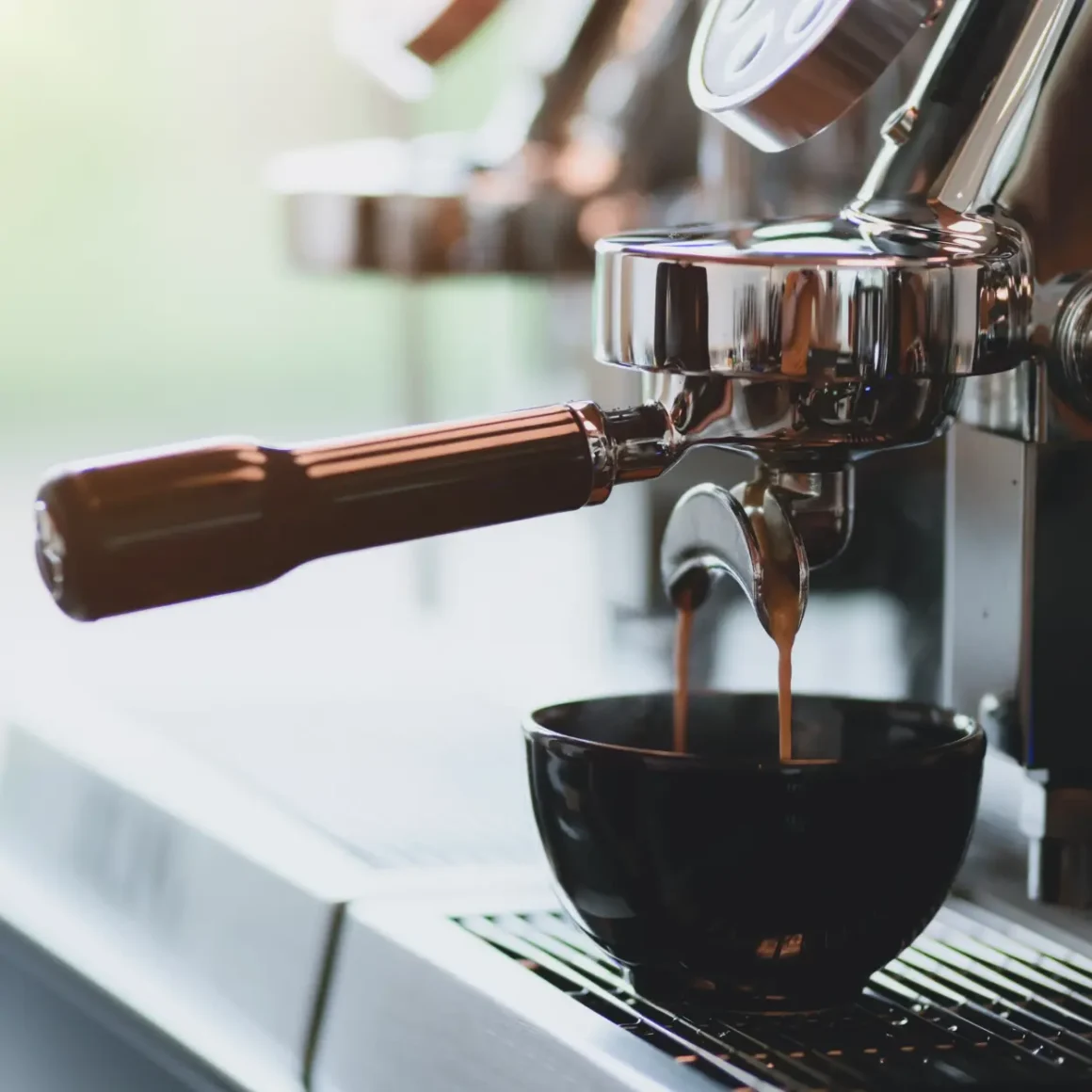 an espresso machine pouring coffee into a cup