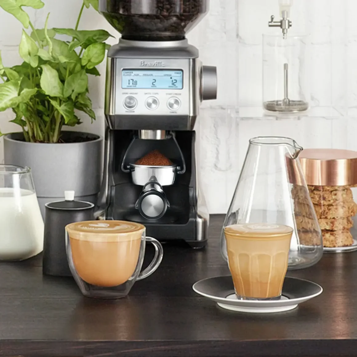 a coffee machine with a cup and a glass of coffee on a table