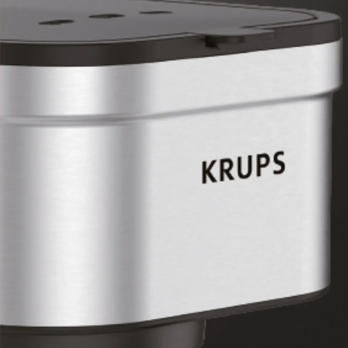 a close-up of a silver and black coffee maker