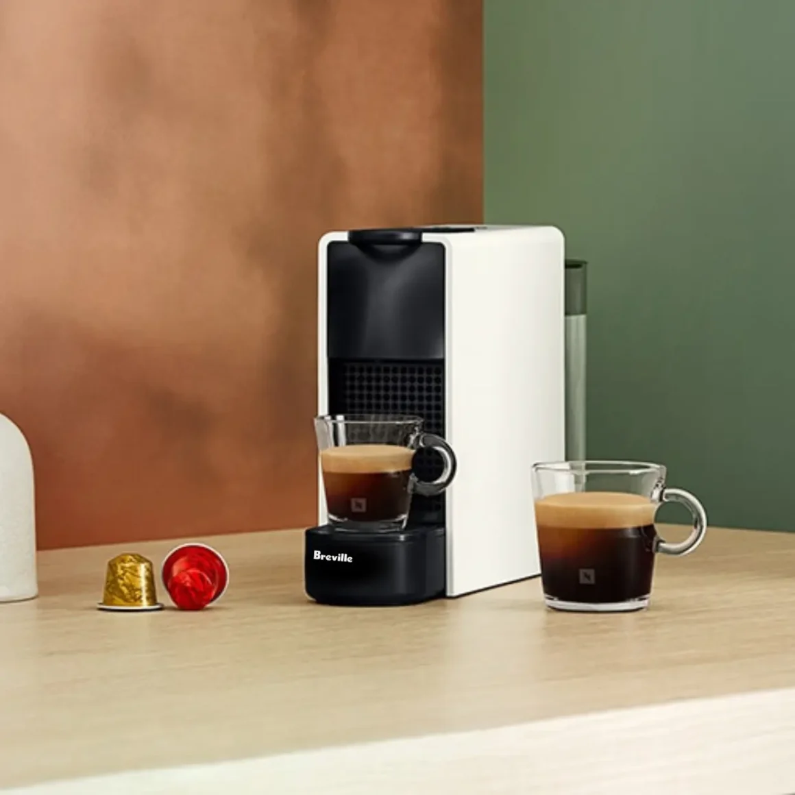 a nespresso essenza mini espresso machine by breville on a table