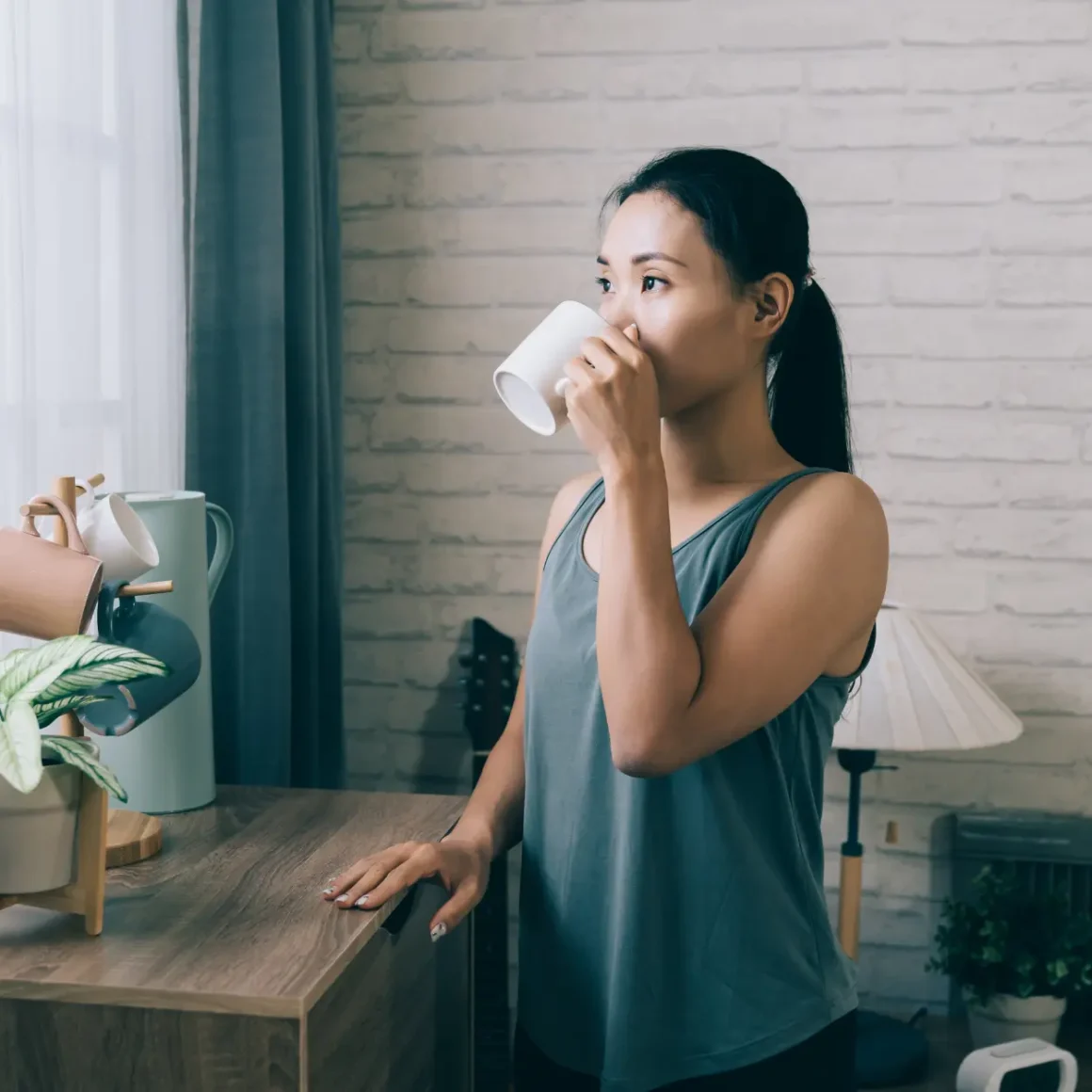 a woman coffee drinking from a white mug
