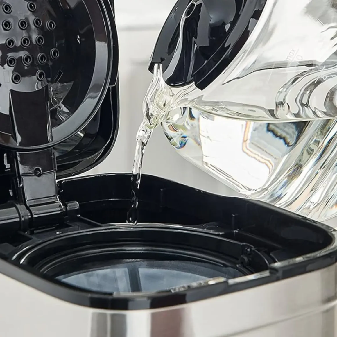 a water pouring into a coffee maker