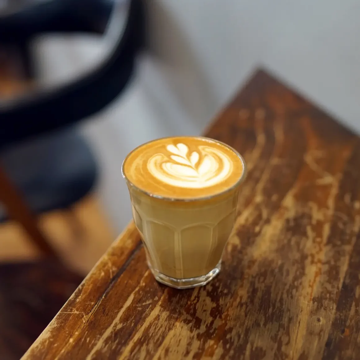 a glass of café con leche on a table