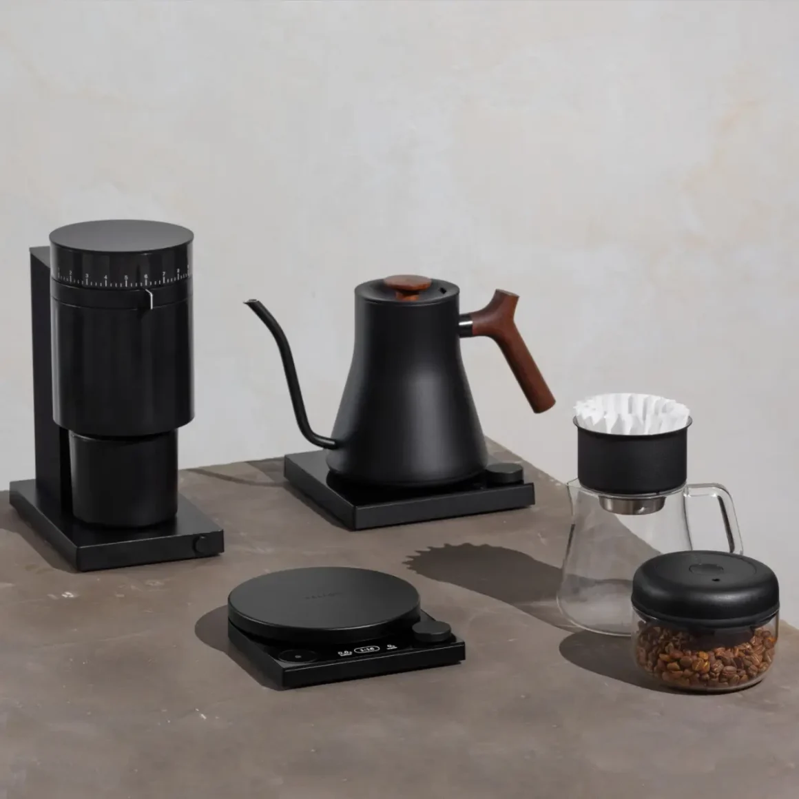 a coffee maker and a fellow stagg ekg electric kettle on a table