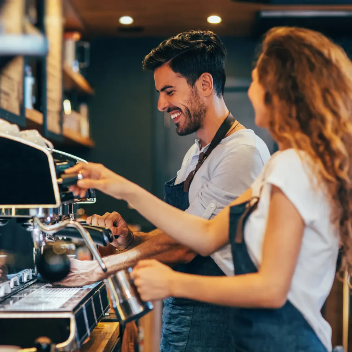 baristas working at an espresso machine