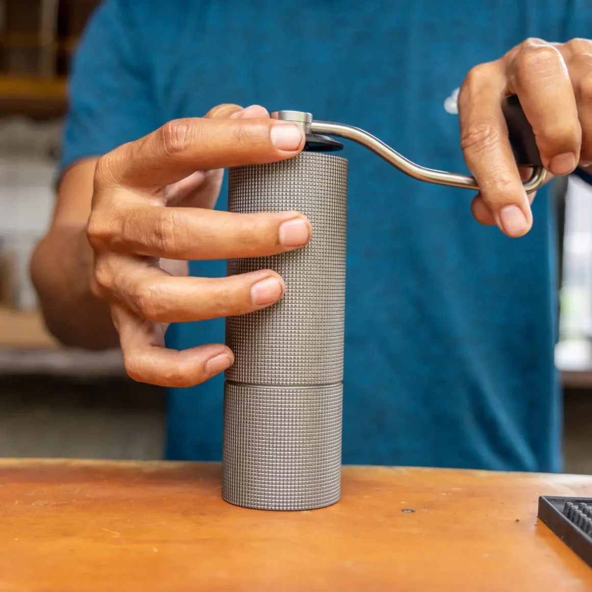 a person using a coffee grinder
