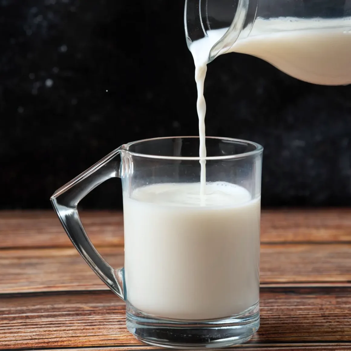 skim milk being poured into a glass