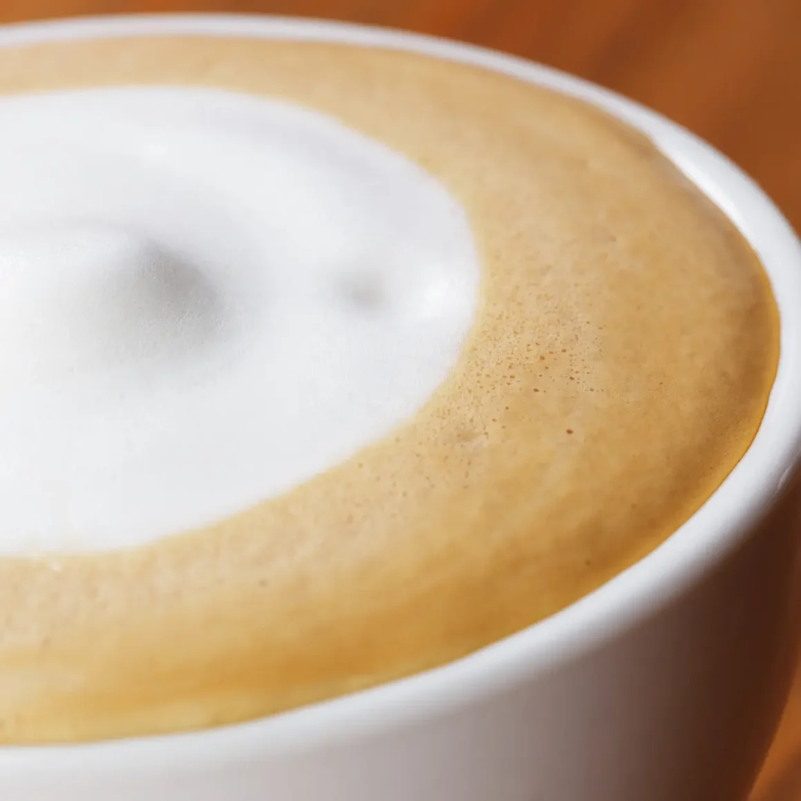a close up of a cup of dry cappuccino coffee