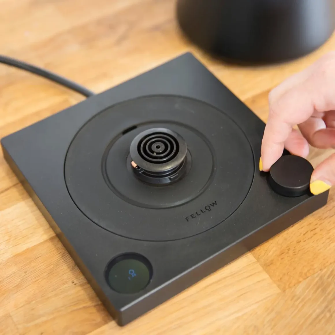 a hand controlling a switch of an electric kettle