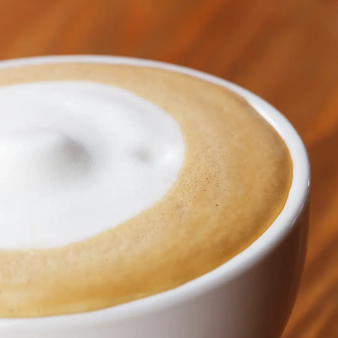 a close up of a cup of dry cappuccino coffee