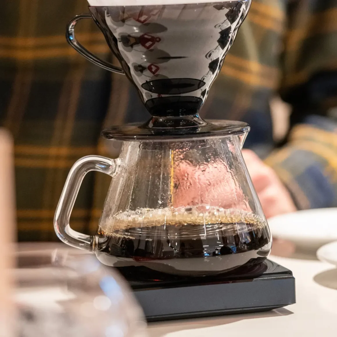 a glass carafe with a coffee dripper on top