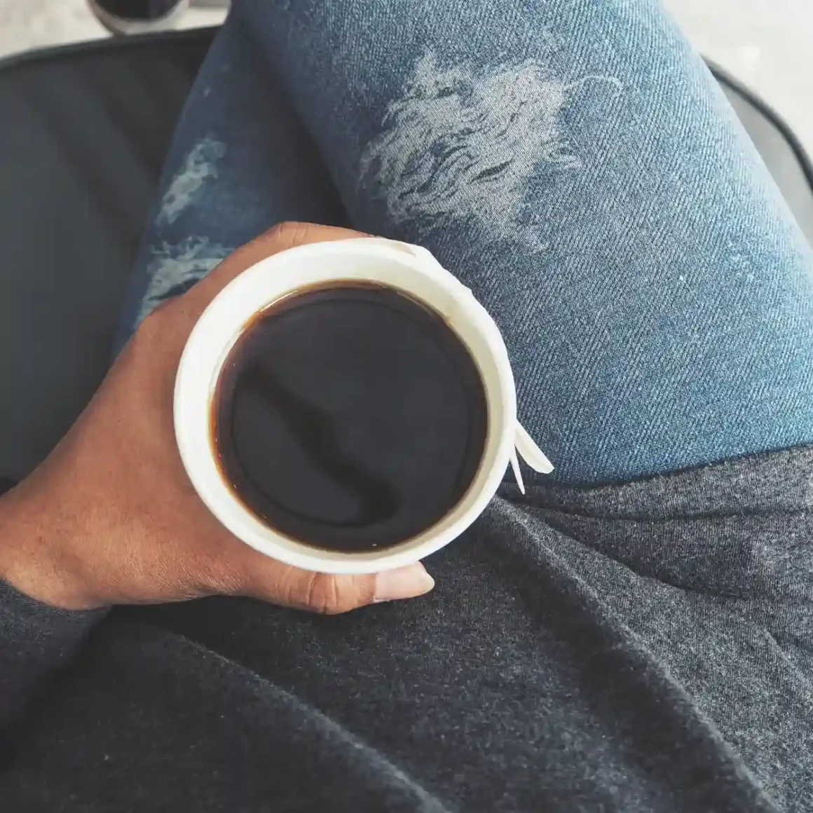 a person holding a cup of coffee