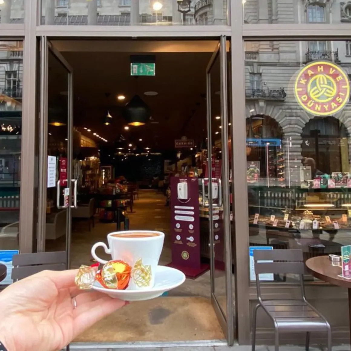 a hand holding a cup of turkish coffee