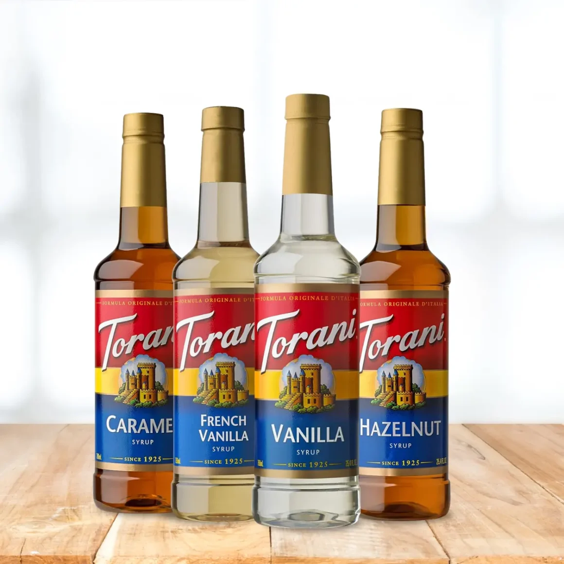 a group of bottles of torani coffee syrups