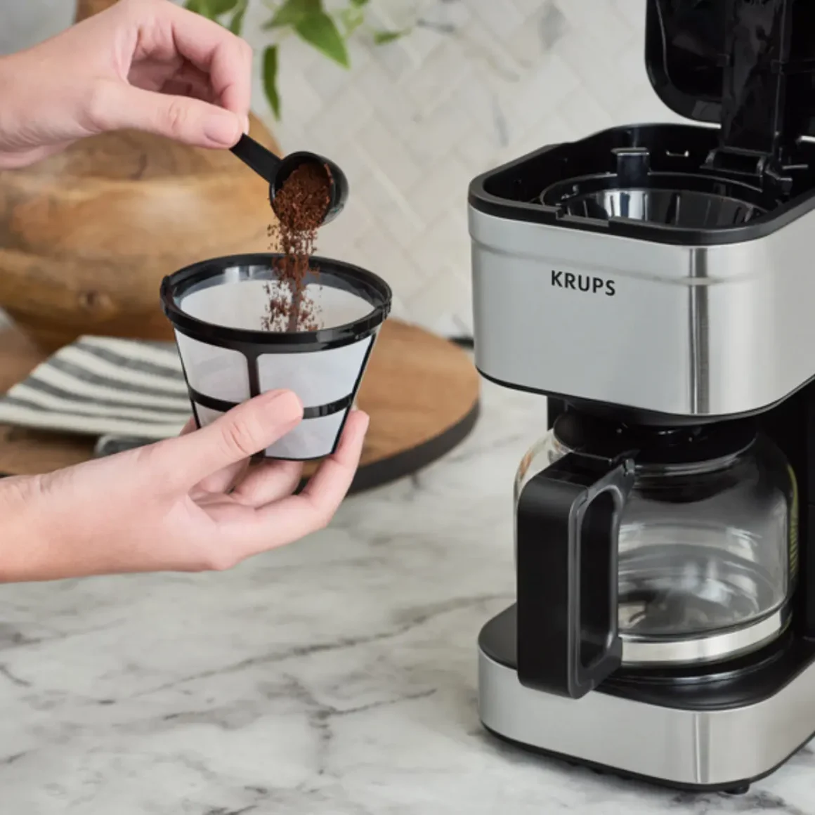 barista pouring coffee into a filter