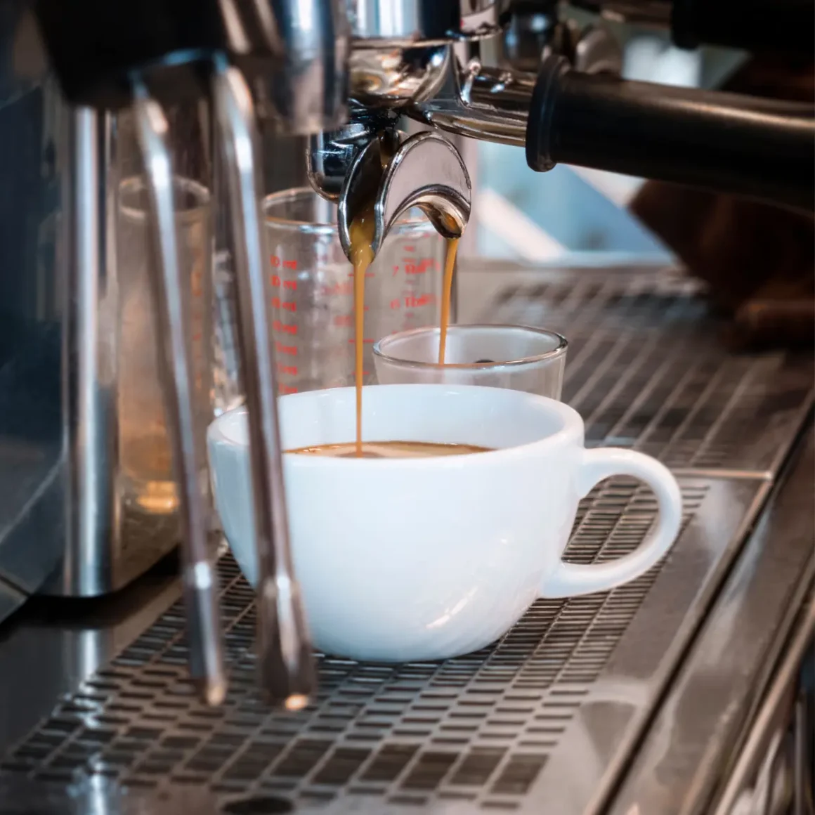 a espresso machine pouring macchiato coffee into a cup