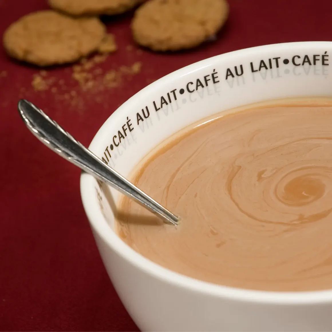 a cup of cafe au lait with a spoon