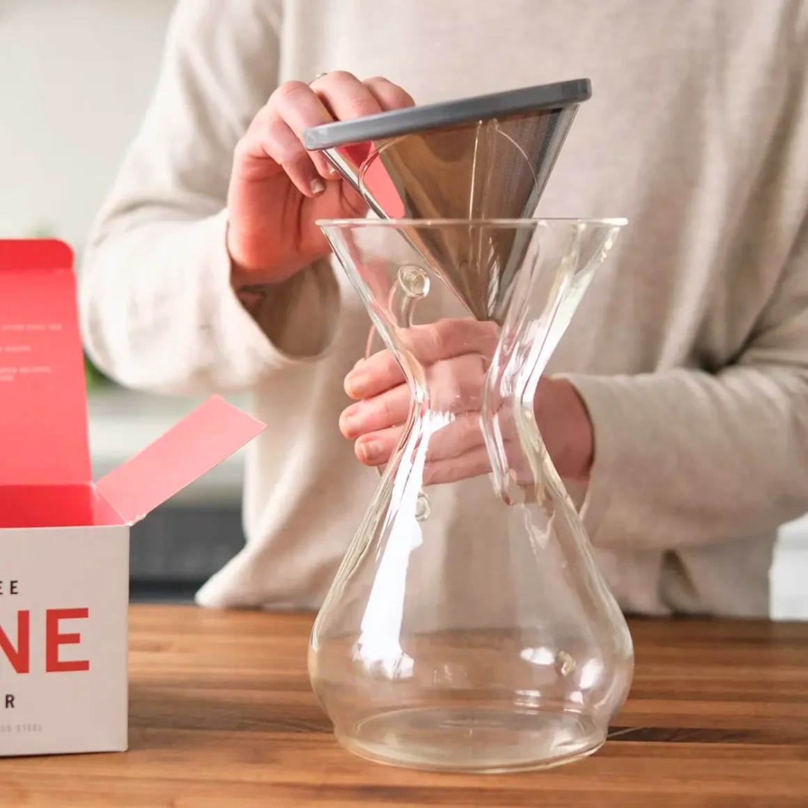 a person holding able kone chemex reusable stainless steel coffee filter