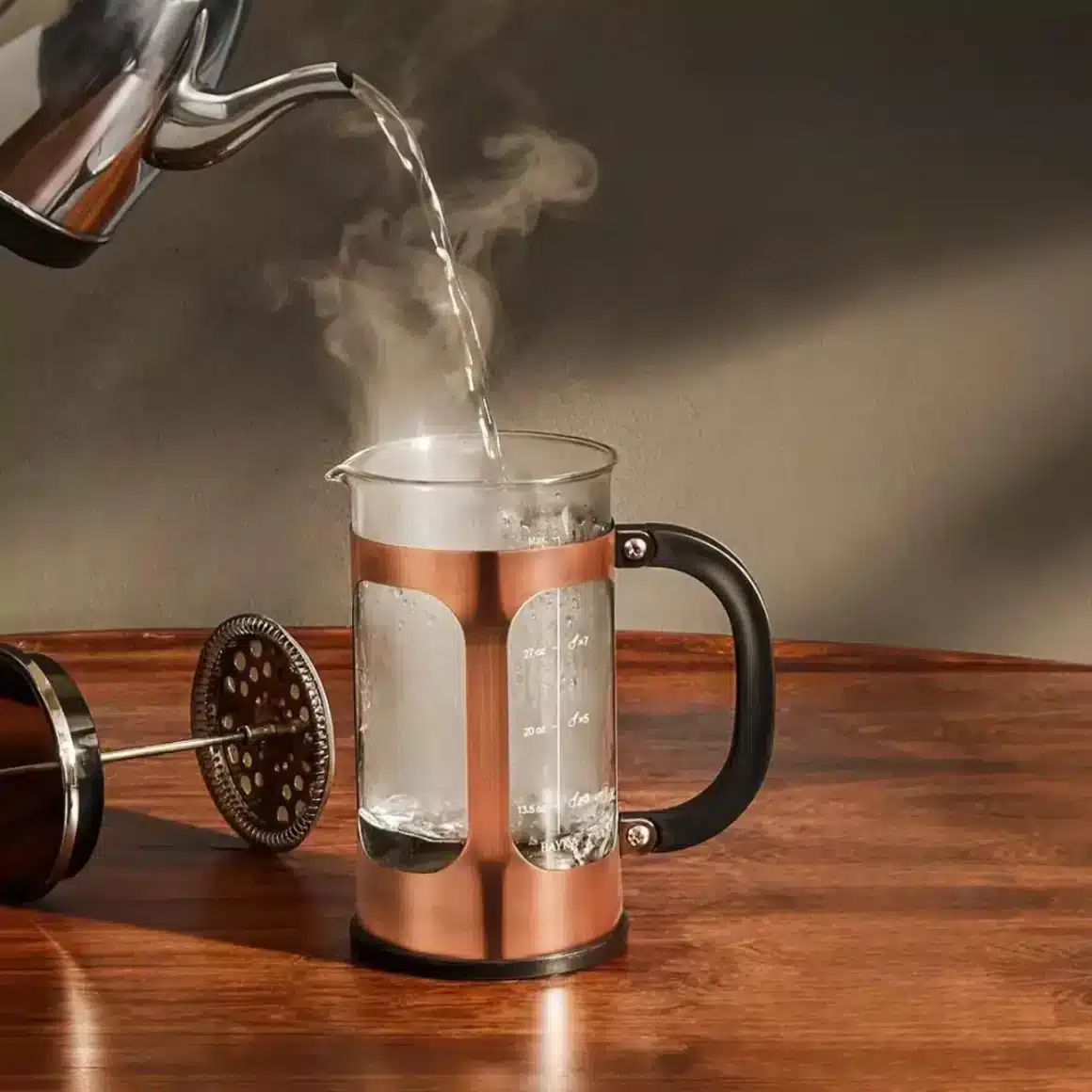 barista pouring water into a coffee maker