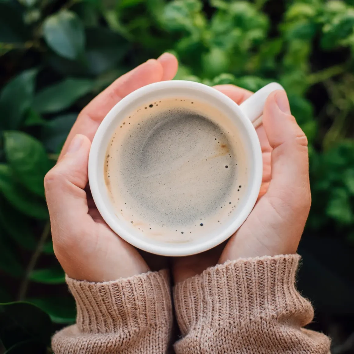 a person holding a cup of coffee