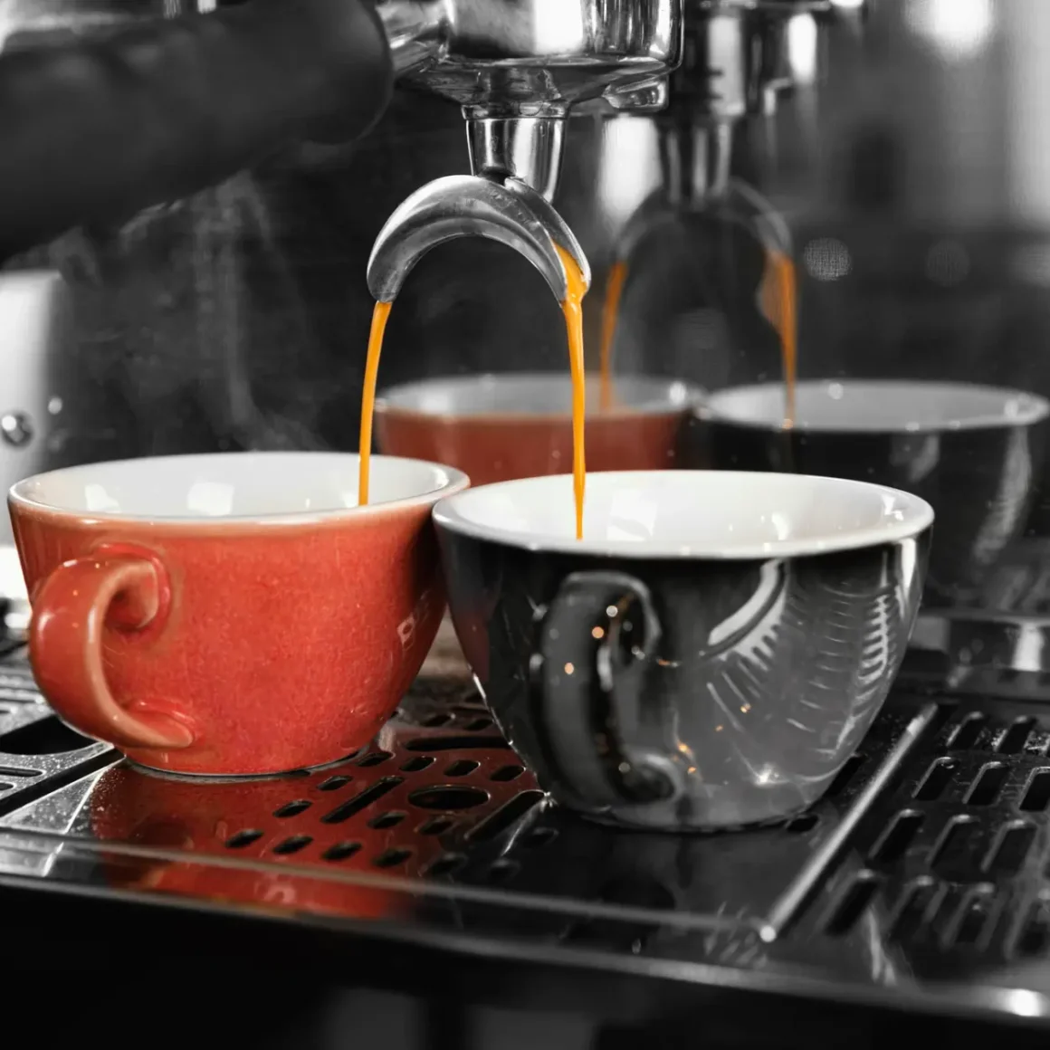 an espresso machine pouring blonde espresso in two cups