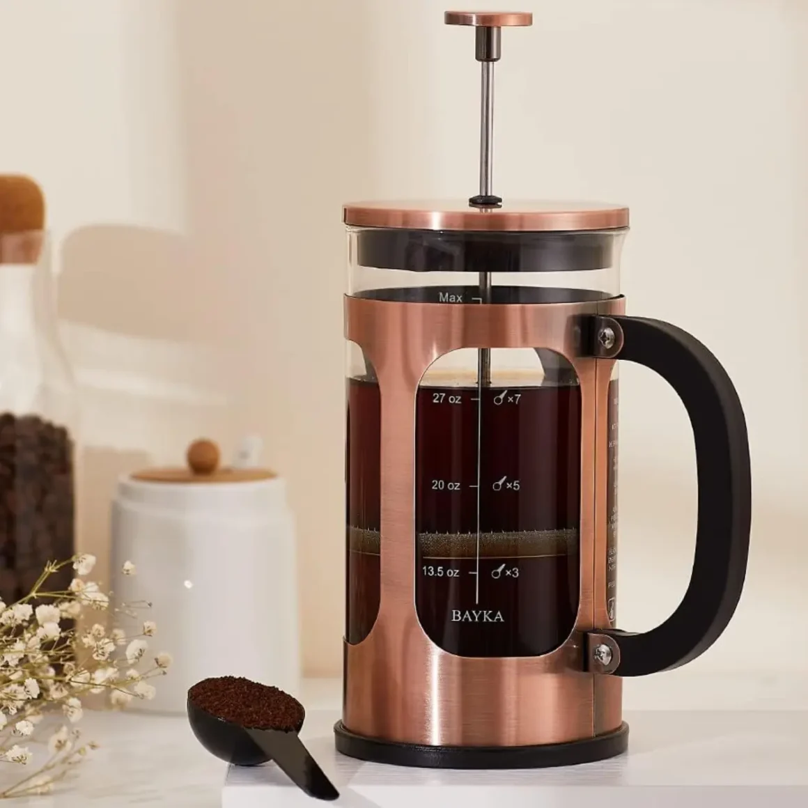 a bayka french press coffee maker with a spoon