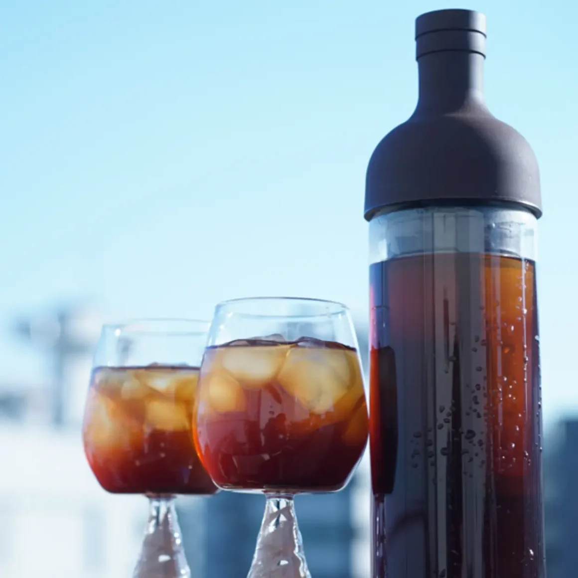 a hario coffee cold brew bottle and glasses of coffee