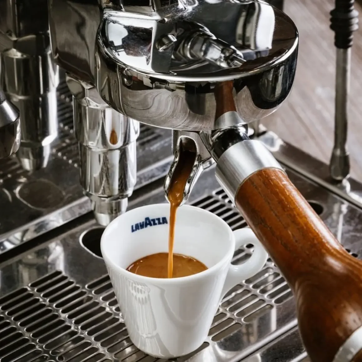 an espresso machine pouring a cup of coffee
