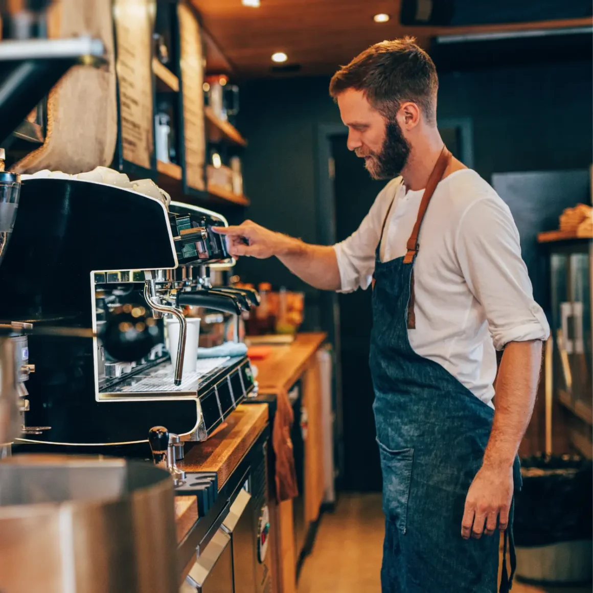 barista brewing coffee using a espresso machine