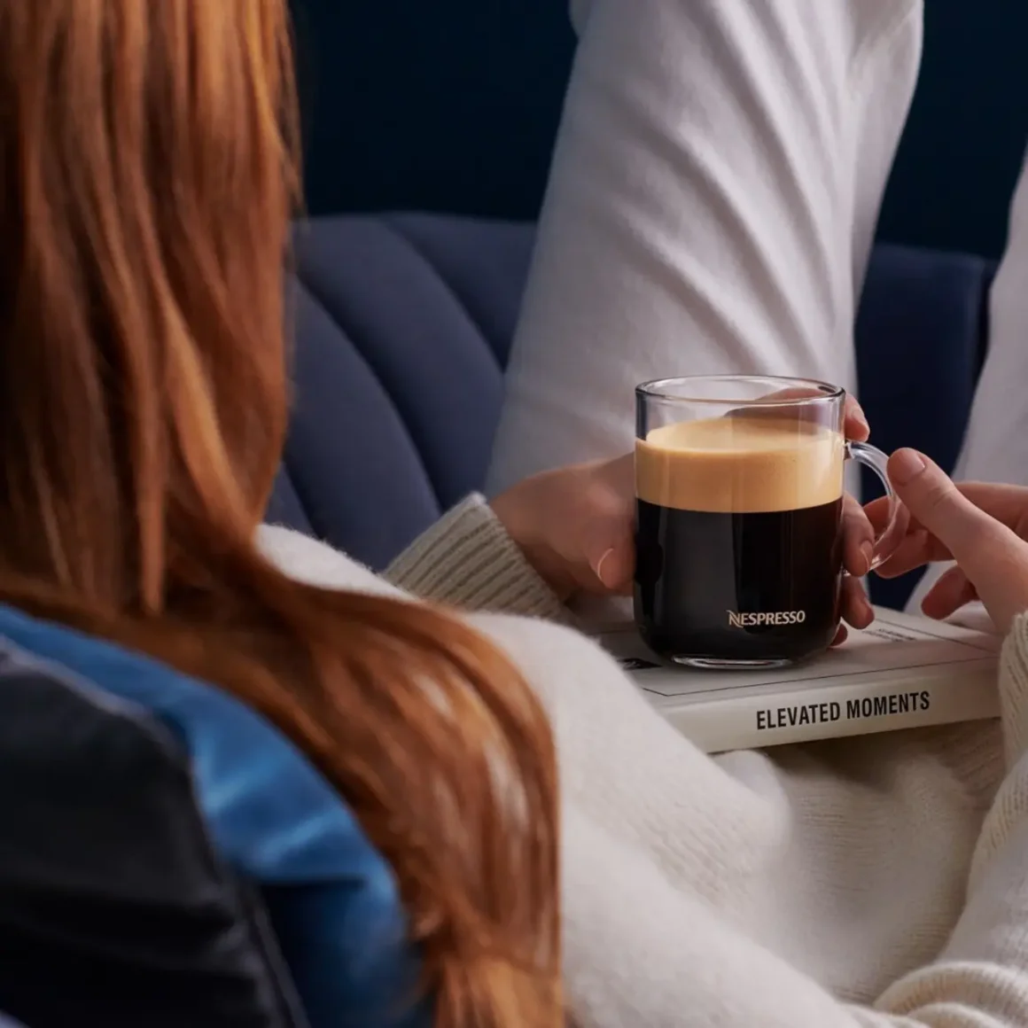 a person holding a cup of coffee