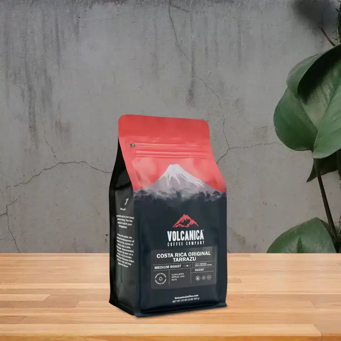 a bag of costa rica tarrazú decaf coffee by volcanica on a table