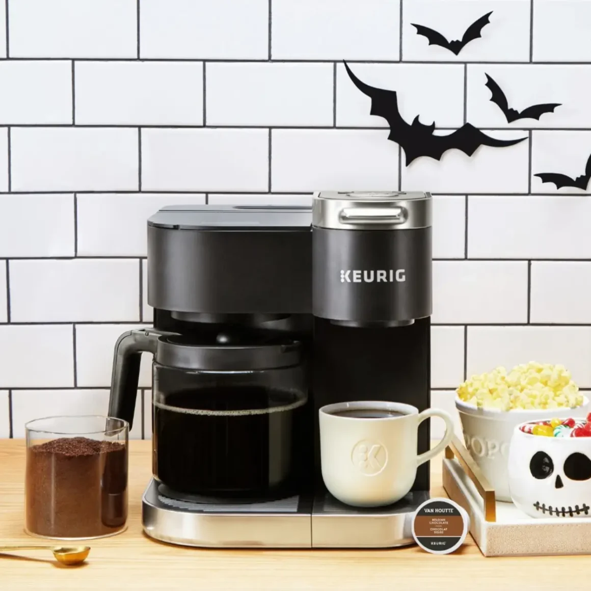 a keurig k-duo coffee maker and cups of popcorn and a tray of coffee
