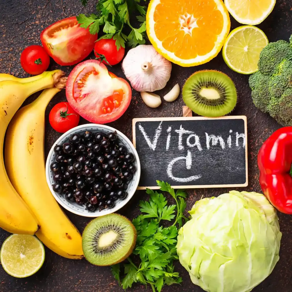 a group of fruits and vegetables around a chalkboard
