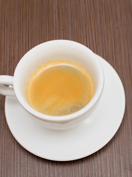 a cup of blonde espresso on a saucer