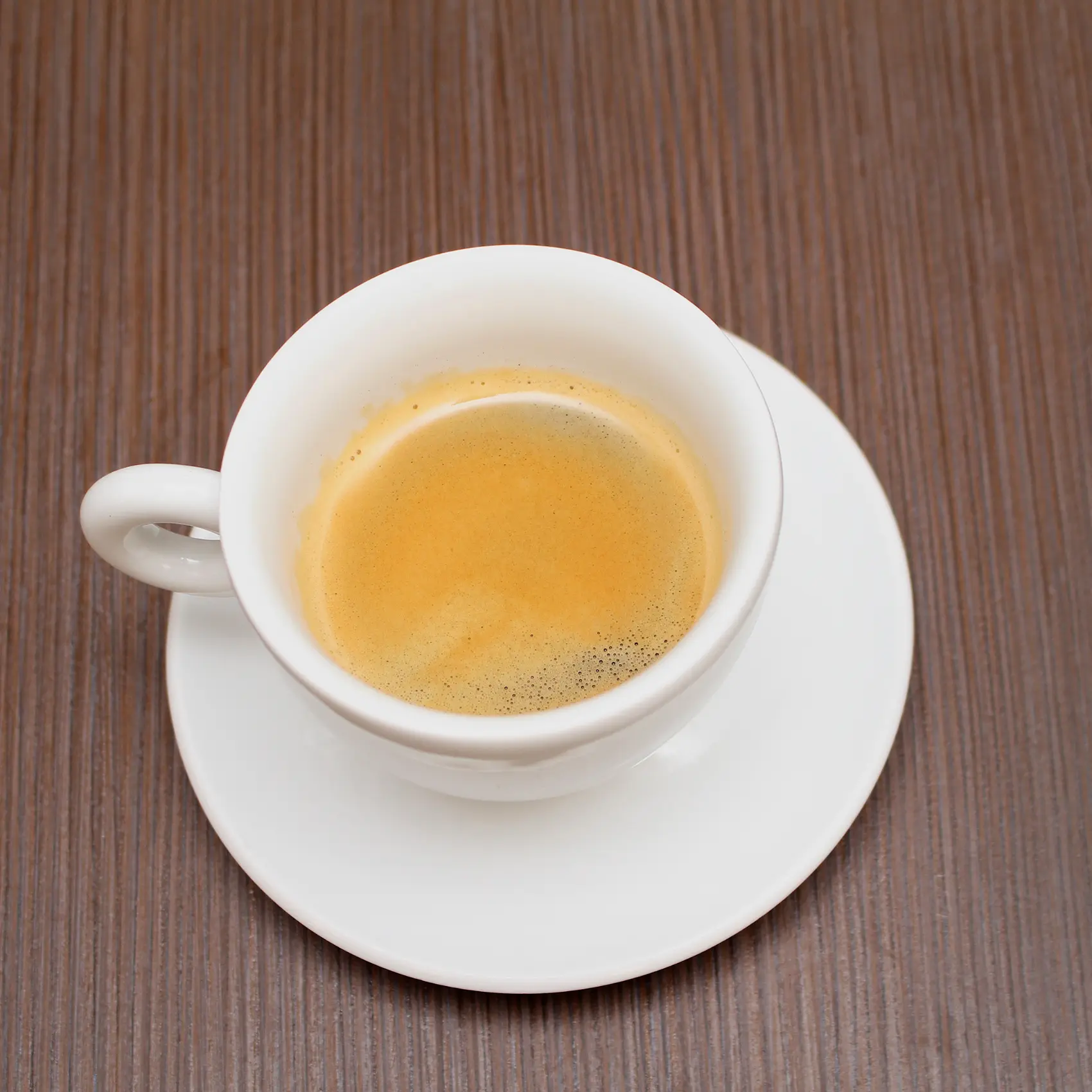 a cup of blonde espresso on a saucer