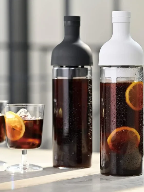 a hario coffee cold brew bottle with a couple glasses of coffee