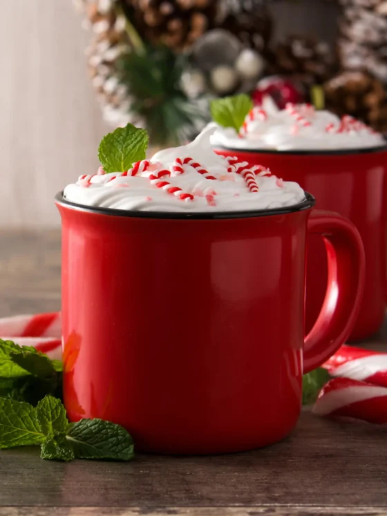 two red mugs of iced peppermint mocha