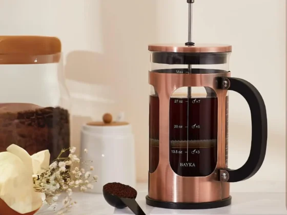 a bayka french press coffee maker with a spoon