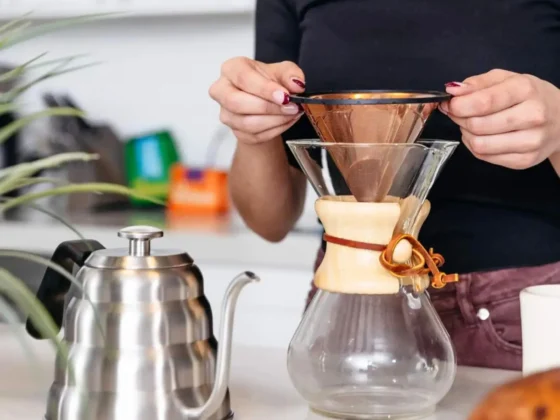 a person holding a barista warrior reusable stainless steel pour over coffee filter