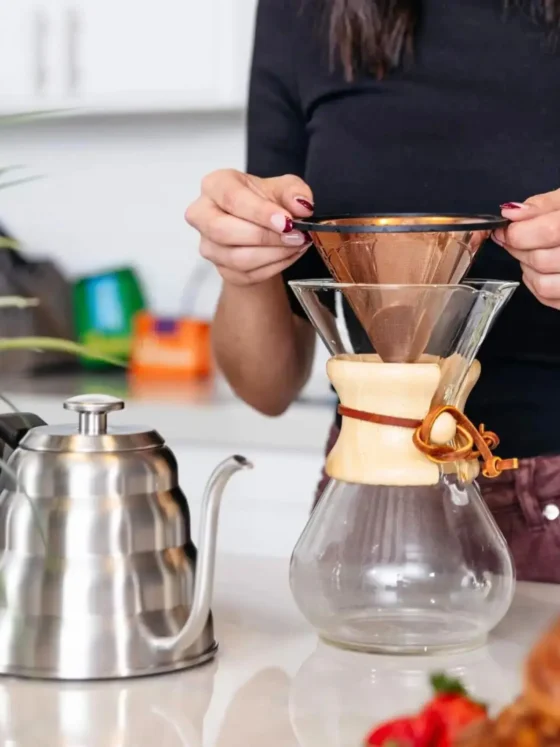 a person holding a barista warrior reusable stainless steel pour over coffee filter