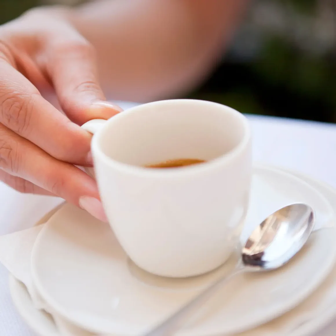 a person holding a cup of blonde espresso